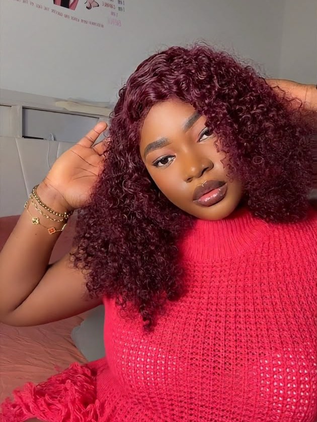 A Kinkie&rsquo;s Place customer wearing a burgundy curly bob