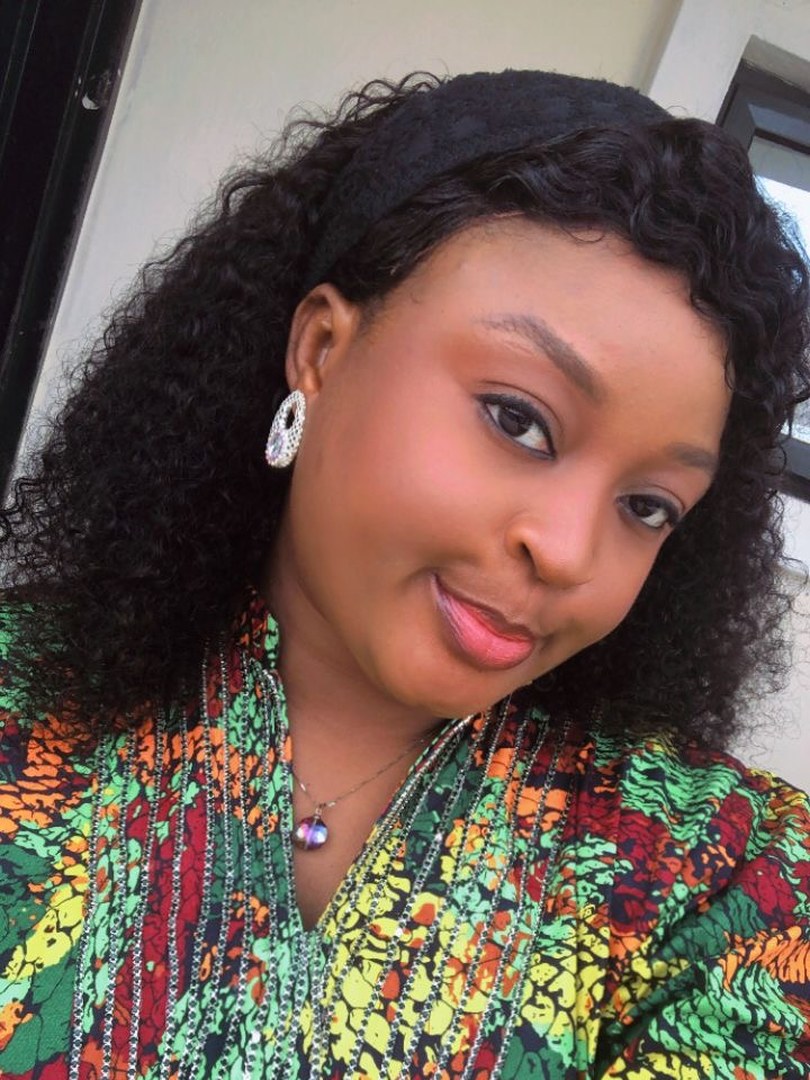 A Kinkie&rsquo;s Place customer wearing a long curly unit